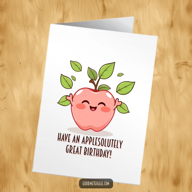 Funny Free Printable Birthday Card: A smiling apple character playfully juggles its own green leaves in a cheerful birthday wish.